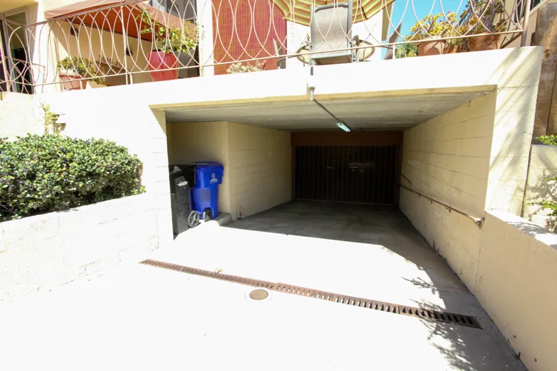 View of garage and waste storage beneath terrace at La Playa Plaza in Point Loma, CA