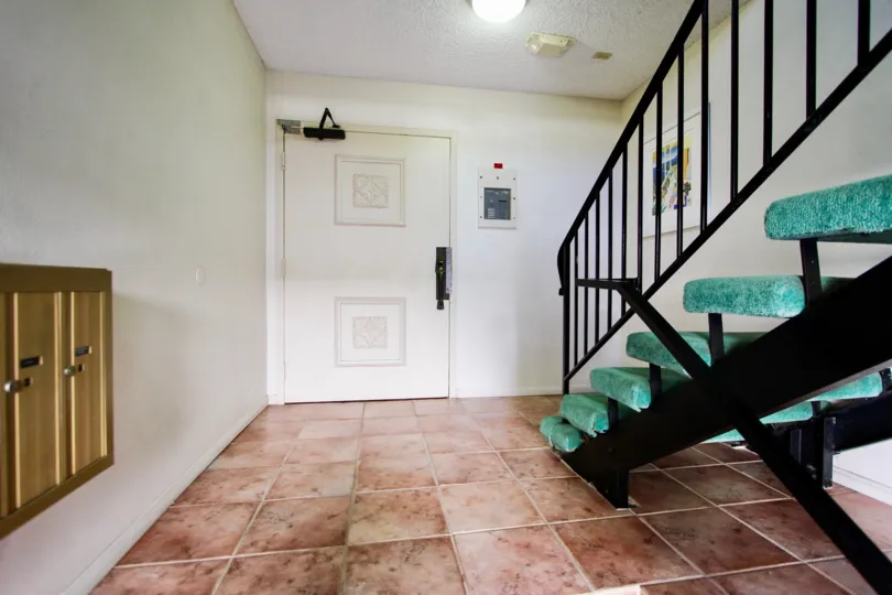 stairs decorated in blue color cloth in front of the door inside the building in La Playa Towers