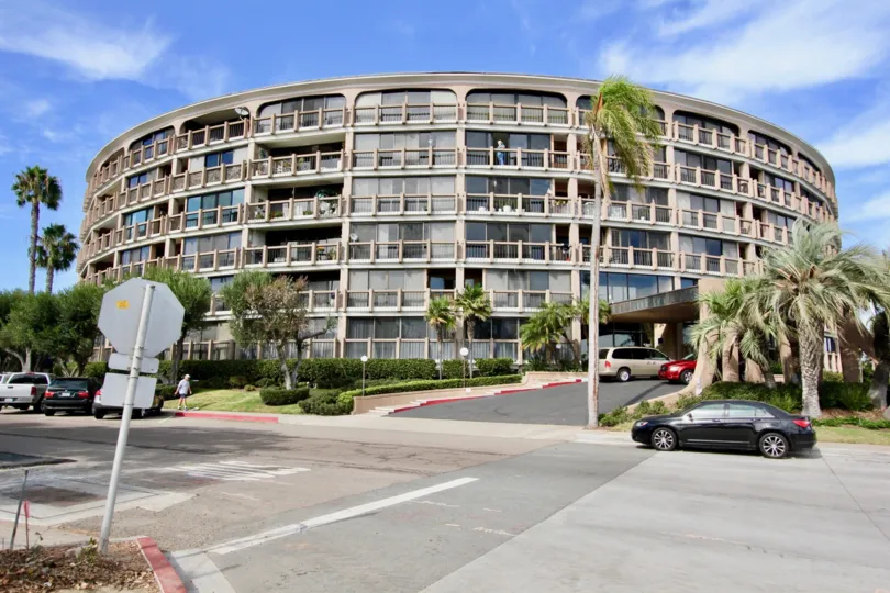 Retro style building exterior located next to major roadway with ample lawn space and trees and unobstructed views of the surroundings at Le Rondelet