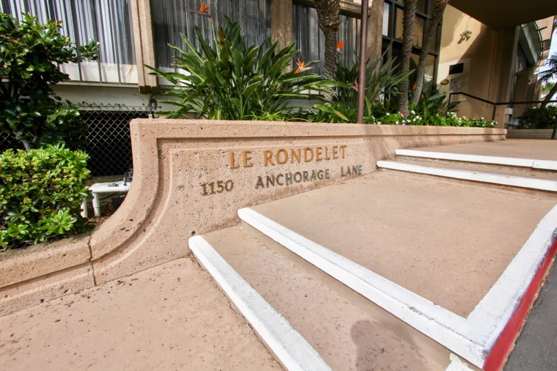 Steps entrance decorated with trees and plants with flowers in Le Rondelet