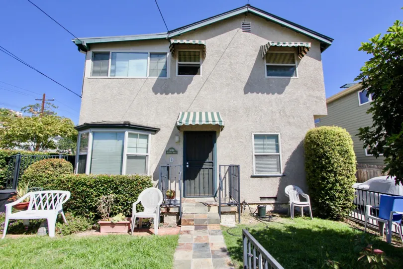 Well maintained front lawn with shrubs at a two storey home in Point Loma