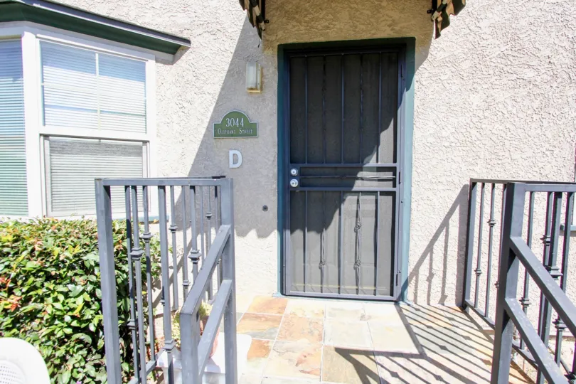 Sun shines on the front door of a house in Oliphant Condos.