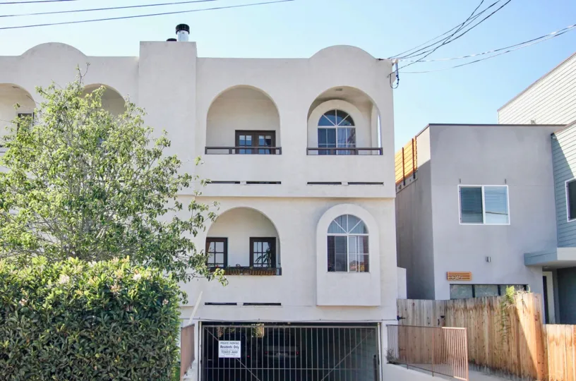 Three story white condominiums with underneath parking at Primrose Villas at Point Loma CA