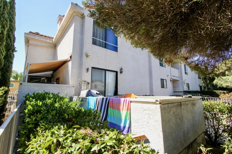 Towels hanging out to dry over deck wall at Roseville Terrace in Point Loma, CA