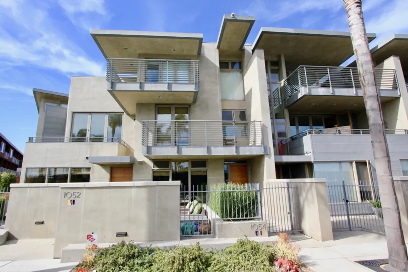 A house with multiple balconies behind a fence in Seven on Anchorage Lane