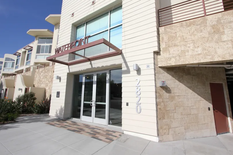 The name of the building sits on top of a glass awning at Waterfront condos