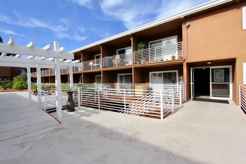 Private terrace for residents with wooden pergola and iron railings at the Yacht Club Condos