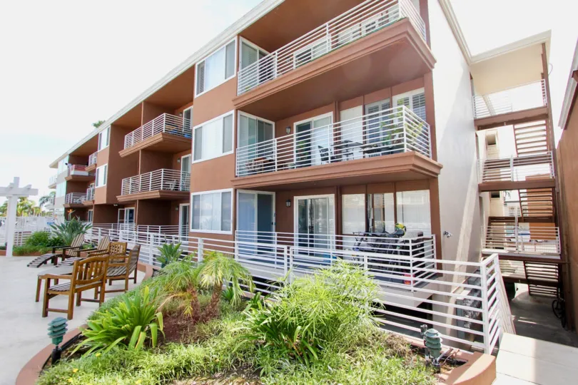 chairs and plants decorated in front of the building in Yacht Club Condos