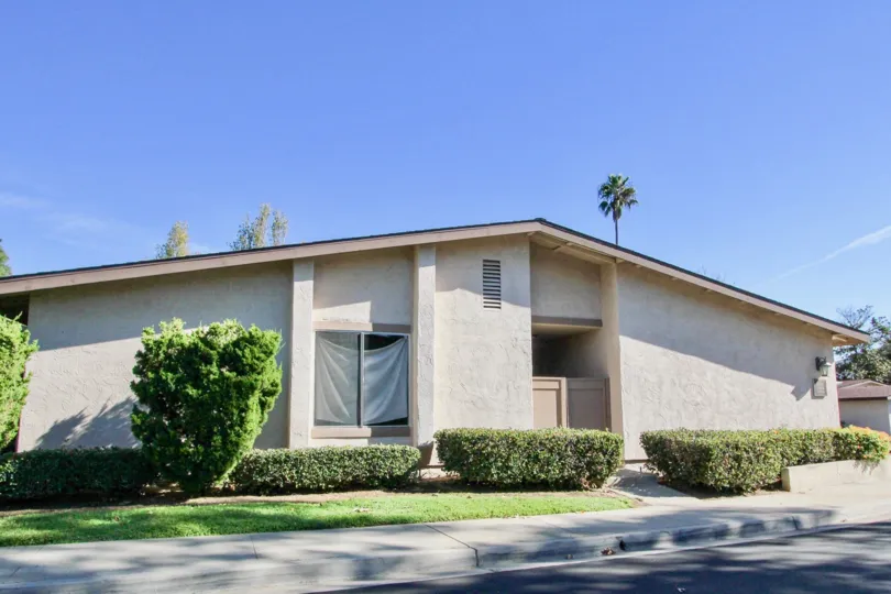 The road side in Alameda has villa with bushes and grasses
