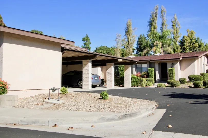 A house with a garage in front and some trees in the back during a sunny day in Alameda, Rancho Bernardo, CA