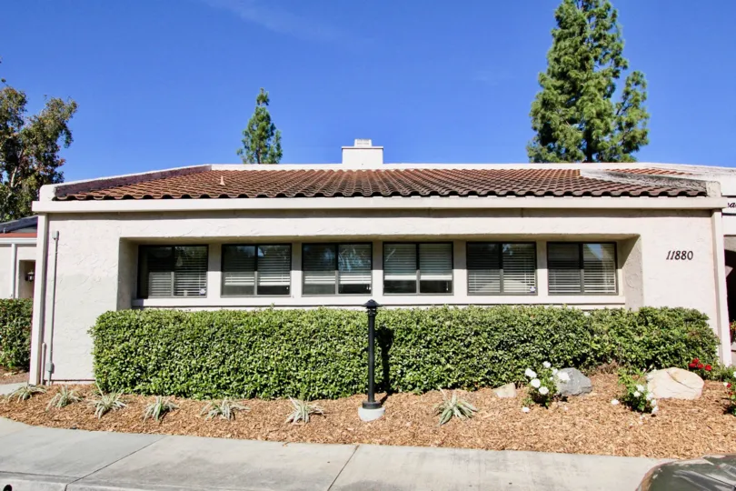 Building with groomed flower bed and shrubs in sunny Rancho Bernardo