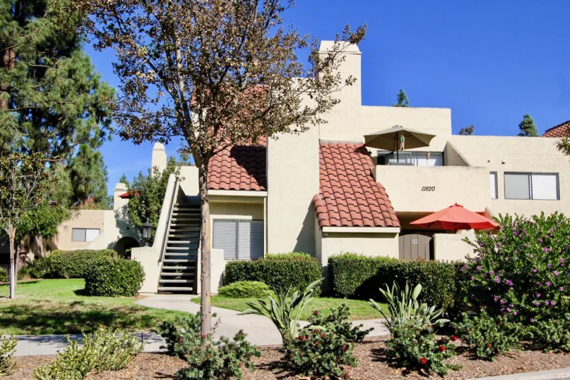 Two story apartments surrounded by plants and trees at Bernardo Pines in Rancho Bernardo CA