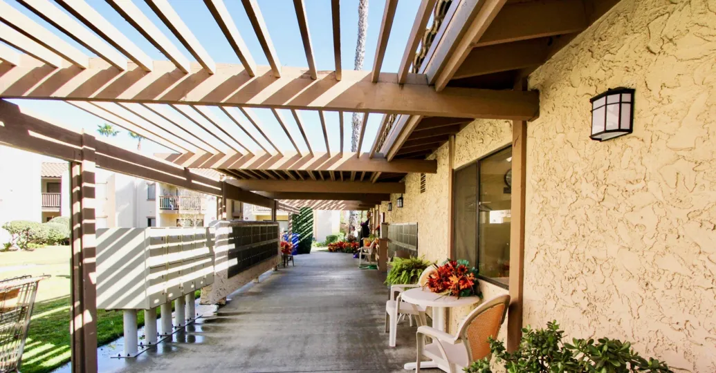 A sunny day in Bernardo Terrace has Lamp and dinning table with flower pot and postal box
