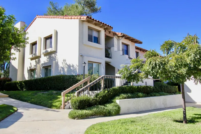 A sunny day in campana Villas with trees and grass with plesant