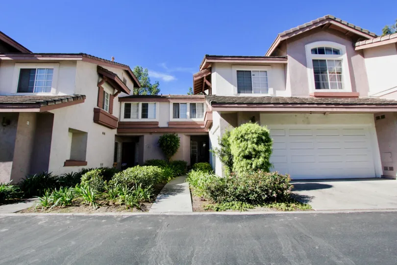A sunny day in the Collage community in Rancho Bernardo with houses and plants.