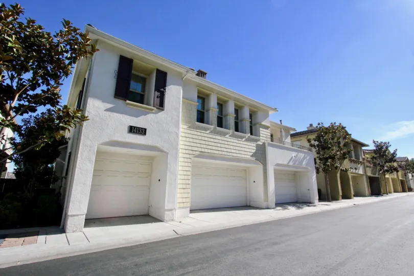 Garages with white doors attached to residence at Cypress Greens in Rancho Bernardo CA