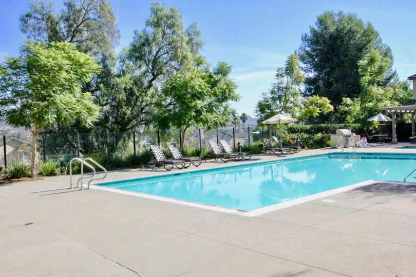 A big swimming pool with some trees in the back at Cypress Greens, Rancho Bernardo, CA
