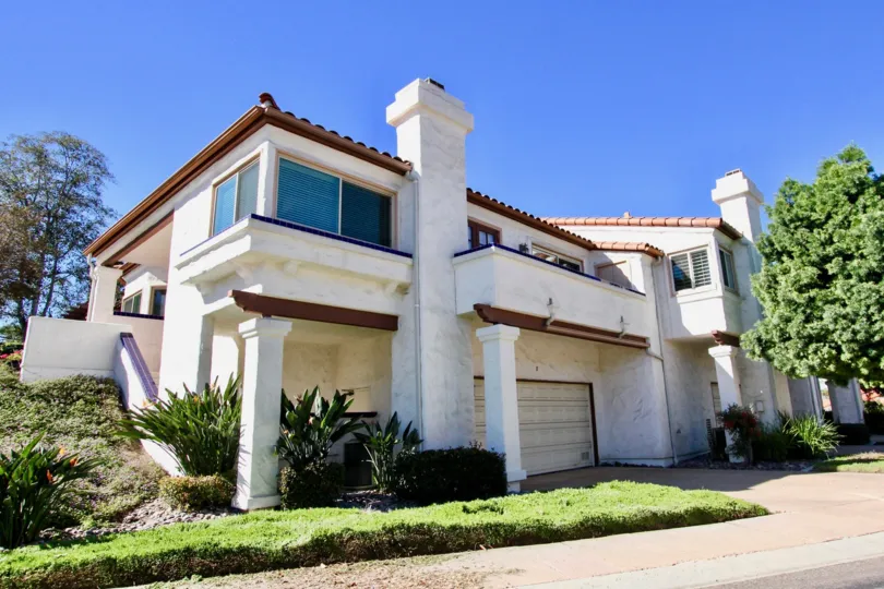 Two story white and brown condo homes inside Fairway Vistas in Rancho Bernardo CA