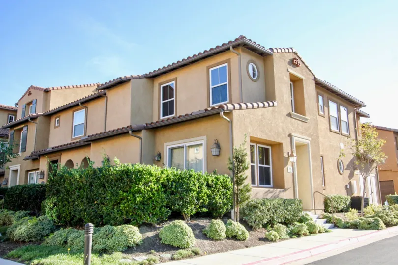 Two story housing with landscaping and sidewalk in Gianni