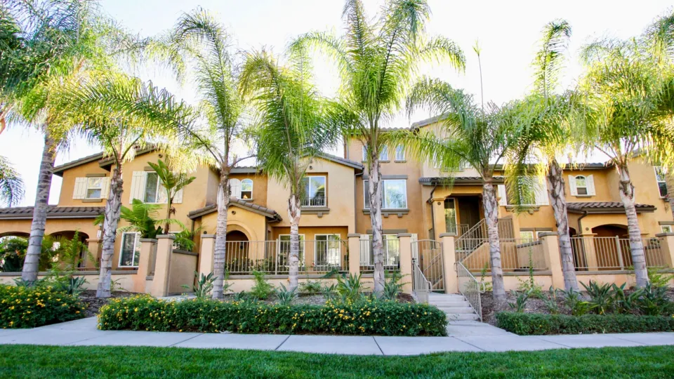Two story born homes with garages and fences inside Gianni at Rancho Bernardo California