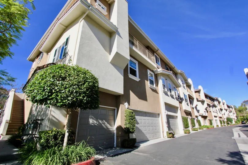 Four story units with garages at their base inside Heritage Villas in Rancho Bernardo CA