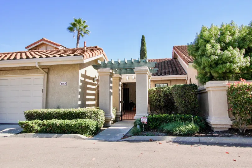 Pink and brown units with plants and pillars inside Las Flores in Rancho Bernardo CA
