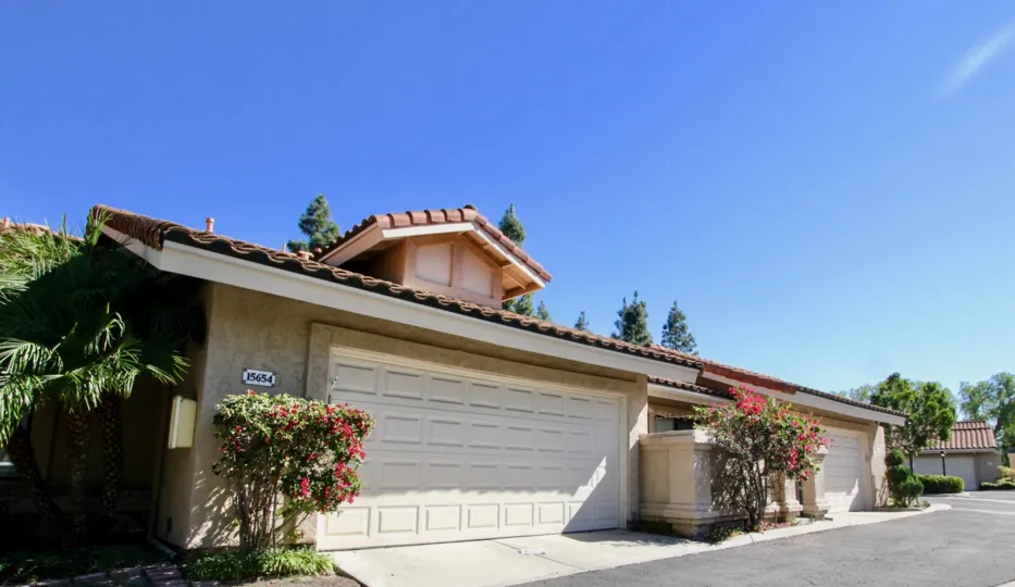 Blue sky behind California home with colorful trees.