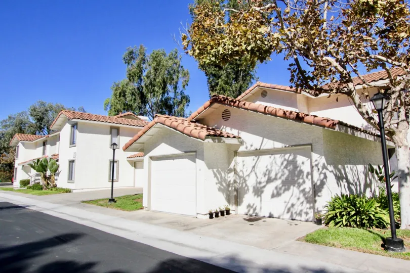 White houses with garages in the front and a sidewalk in Lomas Bernardo
