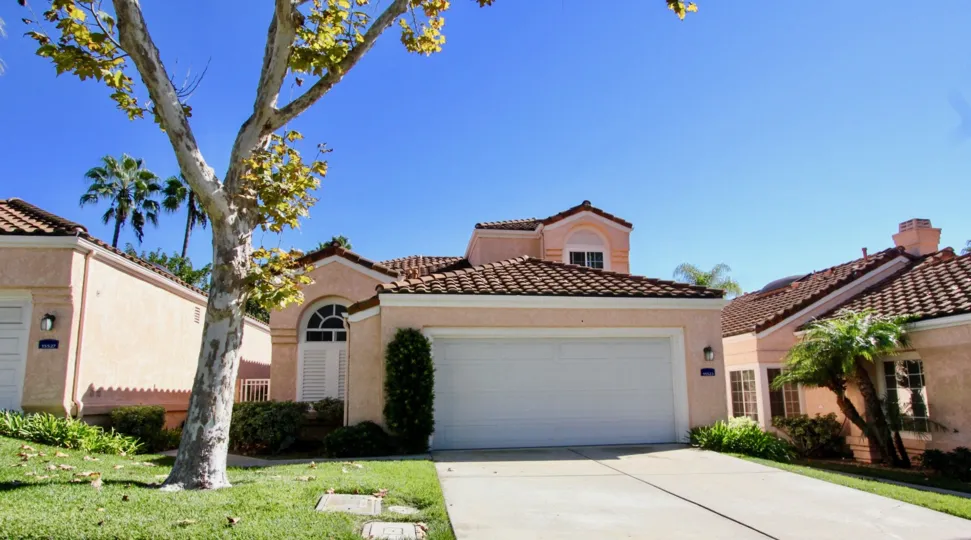 In sunny day of Masters Hill, A villa with grass land and trees along the side of parkway