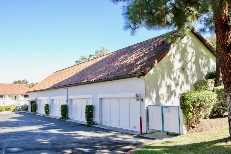 A sunny day in Mira La Paz has villa with trees and bushes