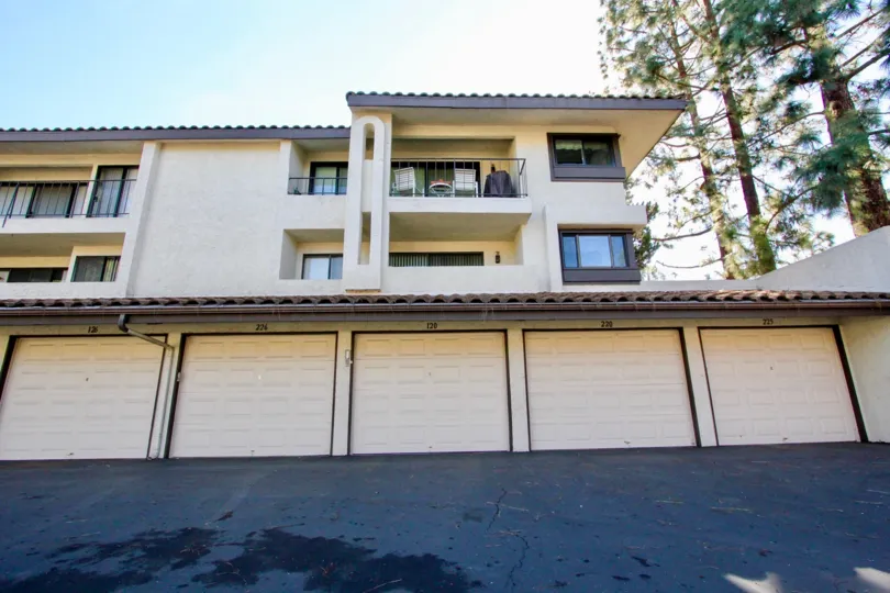 A two story apartment complex with garages below in Oaks North Village