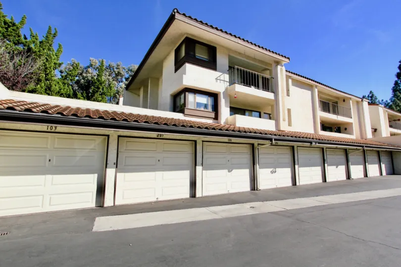 A two story apartment complex with garages below in Oaks North Village from an angle