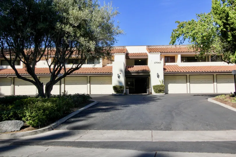The Villa in the Oaks North Village marked as 17647 has long trees and grasses