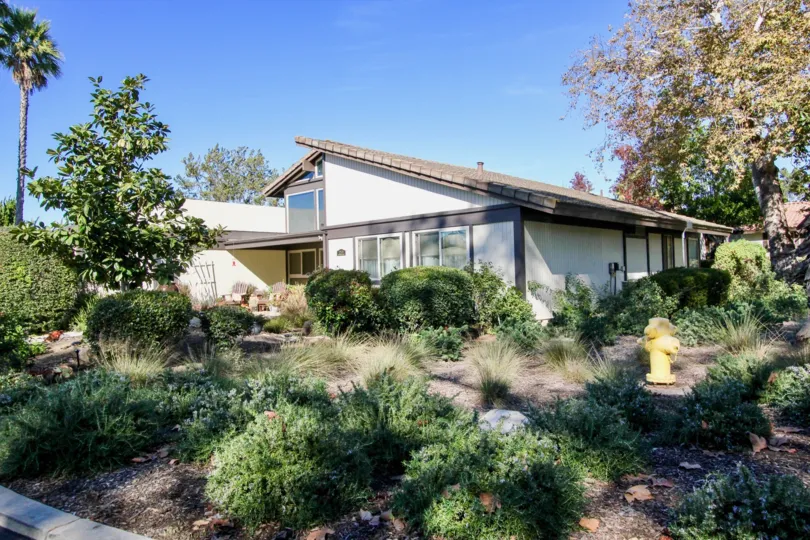 In oaks north Village, Villa is cover with grass, trees and plants