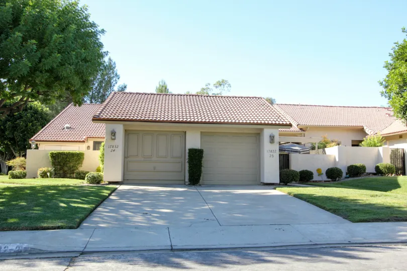 Gray pavement driveway near garages at Oaks North Villas in Rancho Bernardo CA
