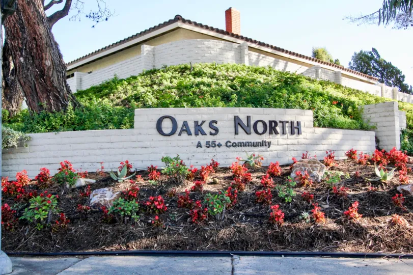 Brick community sign with black lettering outside of Oaks North in Rancho Bernardo CA