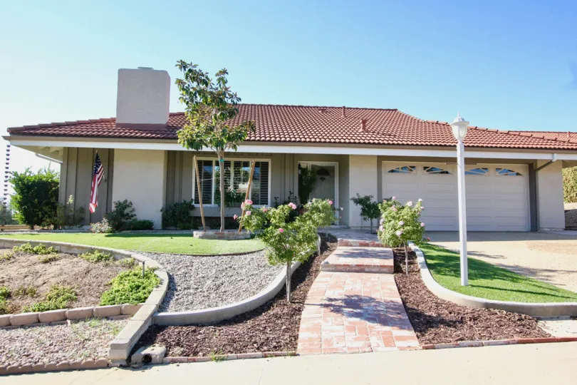 Single story housing with pink rooftop inside Oaks North in Rancho Bernardo CA