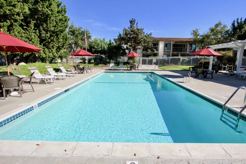 A suuny day in One Oaks North has swimming pool and seating chairs for mind relax