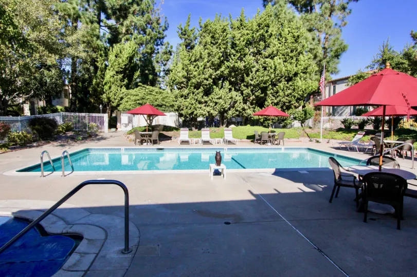 Swimming pool along with baby pool with ample chairs and tables of One Oaks North.