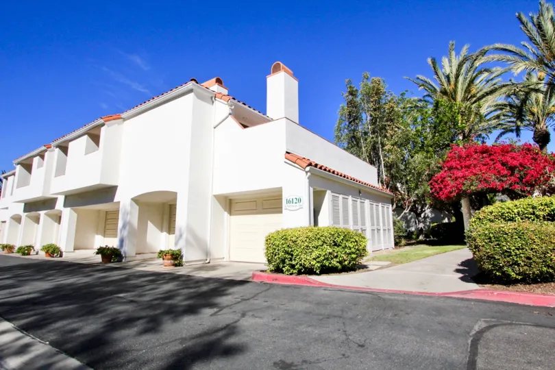 Black driveway near plants and two story residential units at Palazza Bernardo in Rancho Bernardo CA