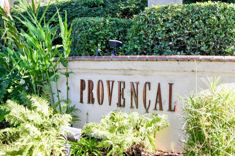 A sign saying "Provencial" surounded with bushes during a sunny day in Provencal, Rancho Bernardo, CA