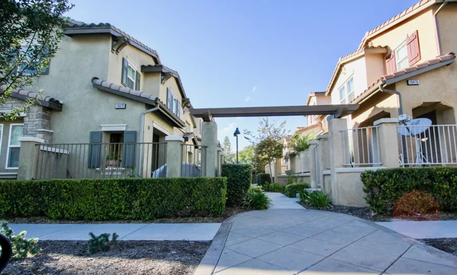 A neighborhood in Ravenna with a sidewalk and nicely maintained bushes