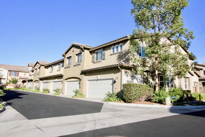 Driveway leading to garage doors and housing at Ravenna in Rancho Bernardo CA