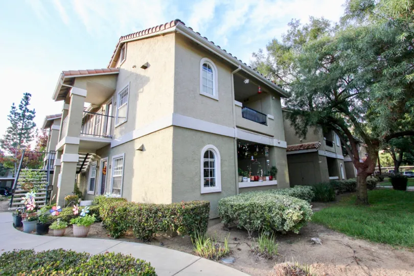 Landscaped yard with potted plants and bushes on corner lot in Sabre Terrace, Rancho Bernardo, California