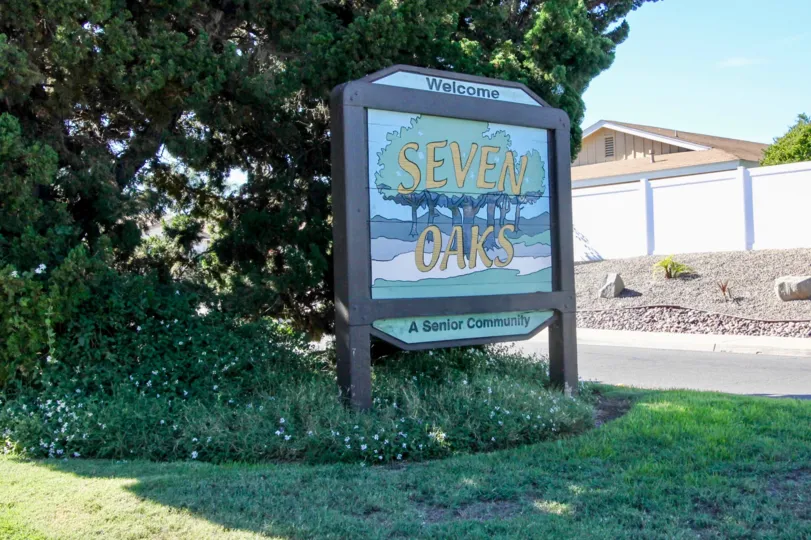 Sign with a pictures of trees in front of Seven Oaks in Rancho Bernardo CA