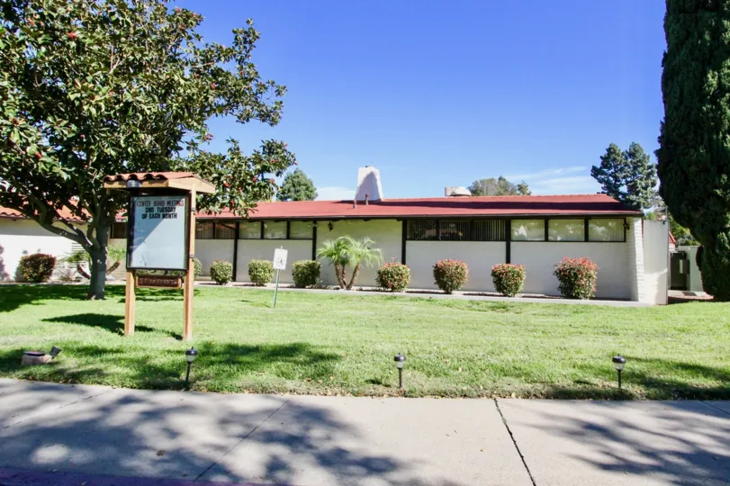 On a sunny day, A villa in Seven Oaks has grasslands, trees, and bushes with notice board
