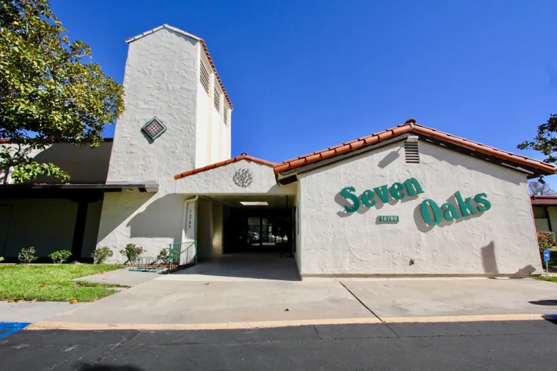 Community center with blue sign on the side inside Seven Oaks at Rancho Bernardo CA