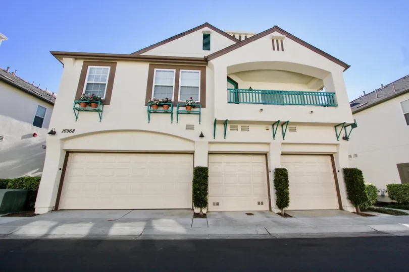 Two story residential building with garages with brown trim inside Sitella in Rancho Bernardo CA