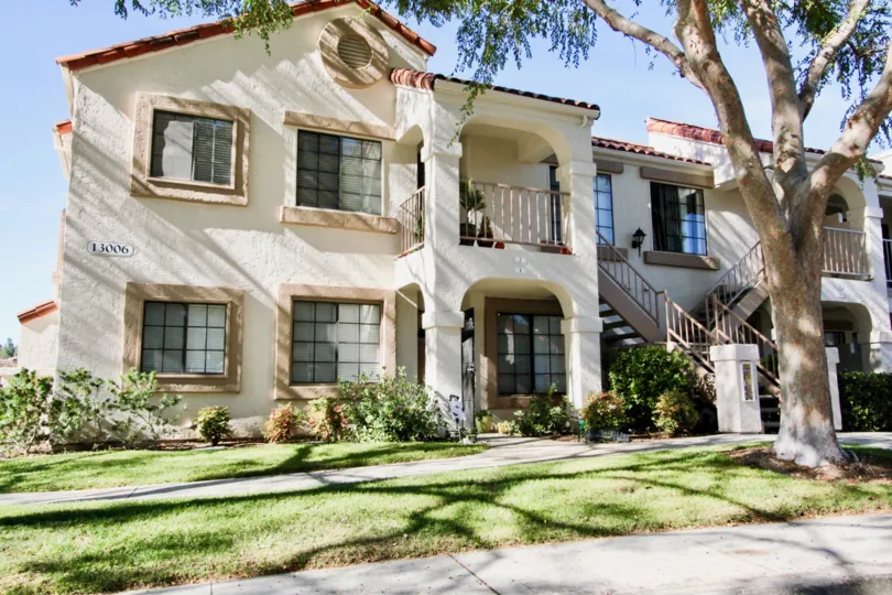 The villas in Stony Brook has a number 13006 with trees and bushes