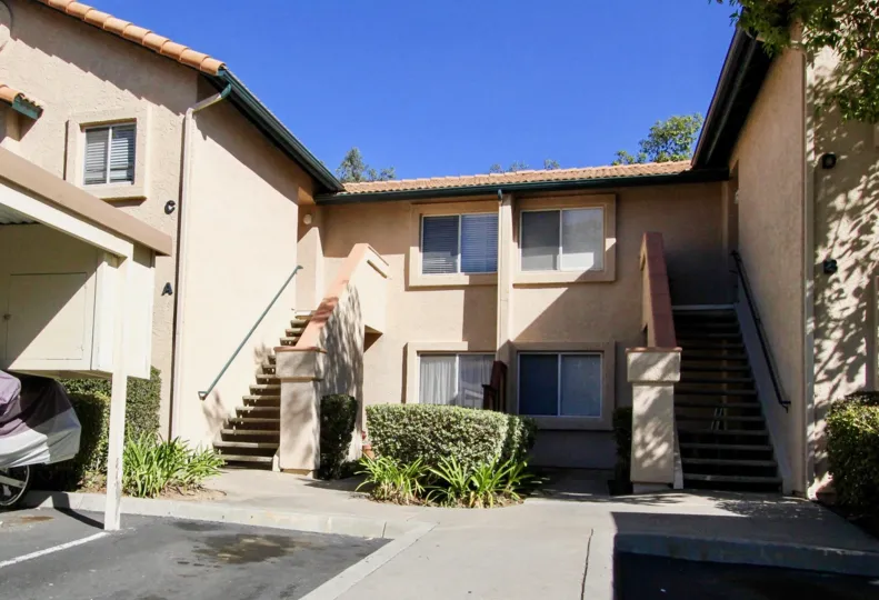 Two stairways attached to a brown residential building at The Falls in Rancho Bernardo California